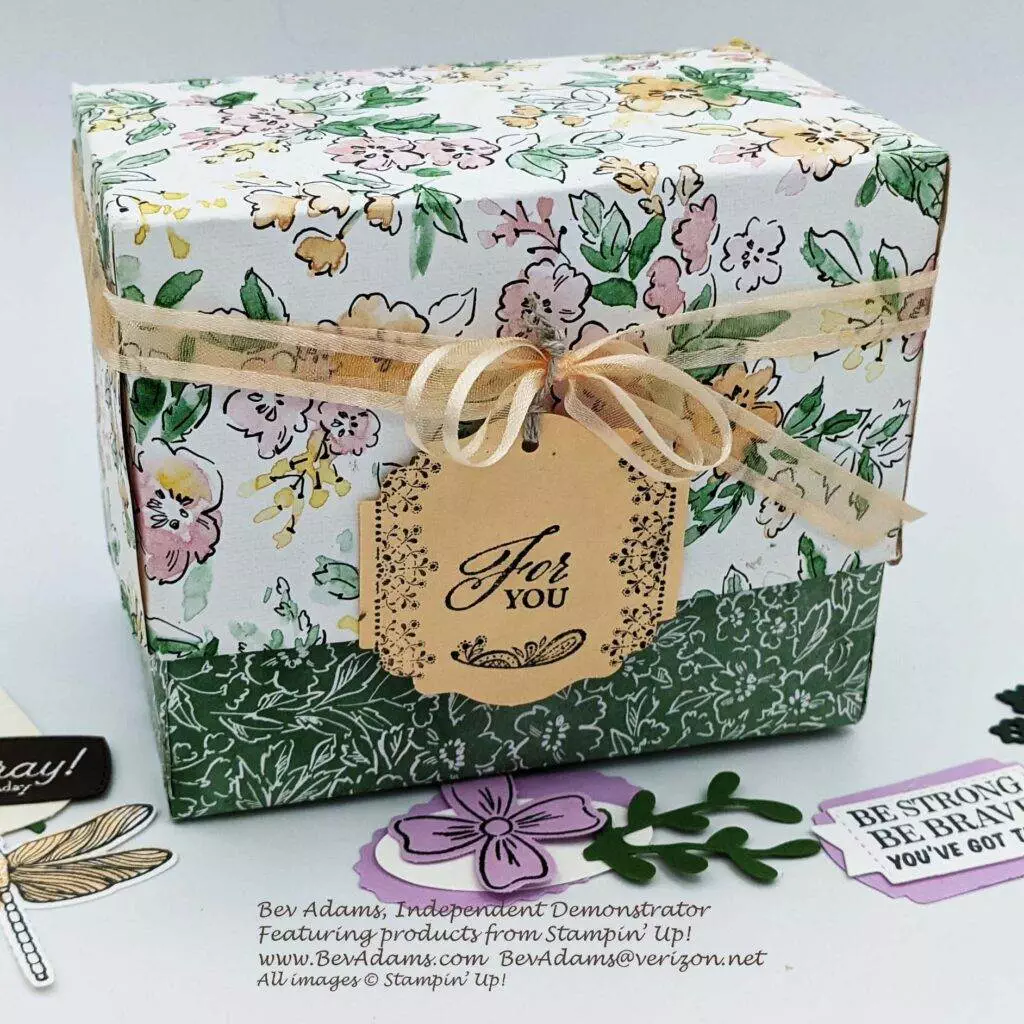 A hand-made box, decorated with a ribbon and a tag. Its made for filing tags as a resource for future projects.